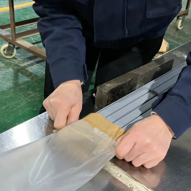 A SIMBA worker packing shower door seals