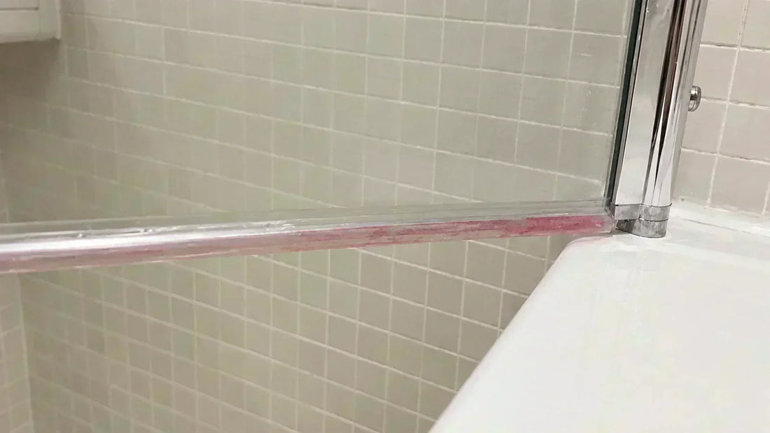 shower screen seal gone pink with pink stains on the bottom shower door seal