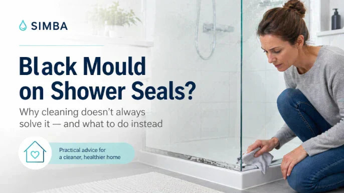 Black mould on a shower door seal in a modern UK bathroom