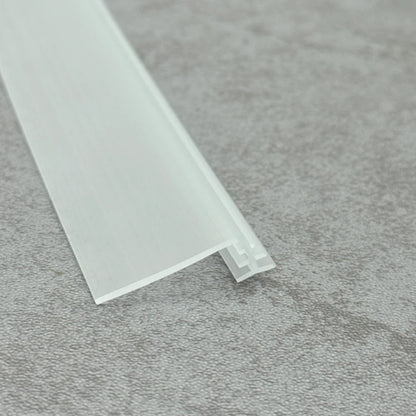VG004 seal sliding into the aluminium bottom track of a framed shower door