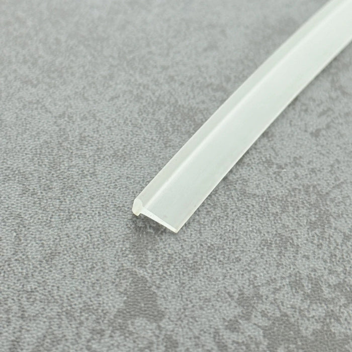 Micro-view of a clear vinyl framed shower door drip sweep wipe seal, showing how the 3mm T-head locks securely within the door frame while the 10mm long soft fin effectively scrapes away water and blocks overflow, ensuring dryness and cleanliness at the base of framed doors.