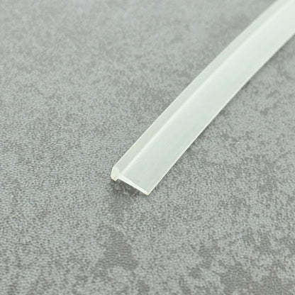Micro-view of a clear vinyl framed shower door drip sweep wipe seal, showing how the 3mm T-head locks securely within the door frame while the 10mm long soft fin effectively scrapes away water and blocks overflow, ensuring dryness and cleanliness at the base of framed doors.