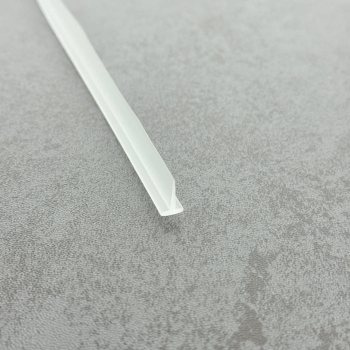 Micro-view of a bath shower framed screen seal, showing how the 4mm T-head locks securely within wider grooves while the 8mm long soft fin effectively conforms to flat floors, providing a tight and durable waterproof barrier at the base of framed screens adjacent to baths.