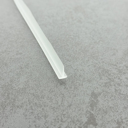 Micro-view of a bath shower framed screen seal, showing how the 4mm T-head locks securely within wider grooves while the 8mm long soft fin effectively conforms to flat floors, providing a tight and durable waterproof barrier at the base of framed screens adjacent to baths.