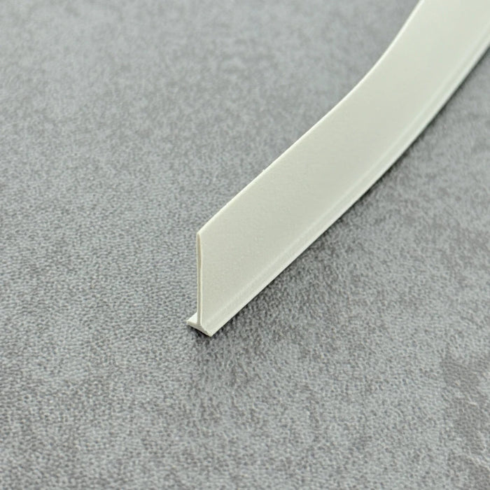 High-clarity close-up of a framed shower door replacement drip rail with vinyl sweep (white version), showcasing the uniform white matte/semi-gloss finish, smooth vinyl surface, and flexibility of the VH005's 16mm fin, highlighting its resistance to yellowing as an ideal accessory to restore the tidy appearance of white shower enclosures.