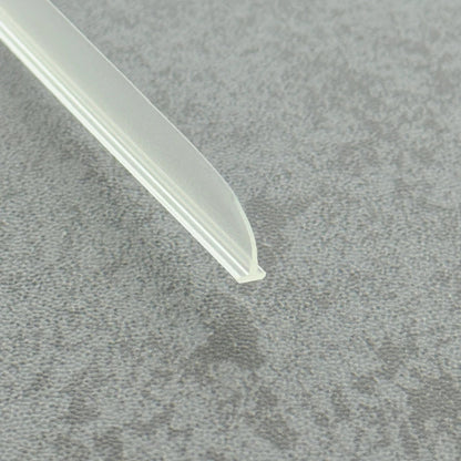 High-clarity close-up of a framed shower door sweep replacement (clear version), showcasing the high light transmission, smooth vinyl texture, and flexibility of the VH003's 11mm fin, highlighting its resistance to ageing as an effective substitute for yellowed or hardened old sweeps to restore the tidy appearance of shower screen bases while remaining virtually invisible.