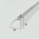 Cross-section close-up of the VE01 shower door sweep framed, showcasing the transparent soft PVC with a unique T-shaped leg paired with an extended side channel, creating a dual leak-prevention barrier, optimized to lock into standard framed door base tracks and direct splashed water towards the drain for more reliable waterproofing than traditional single-strip seals.