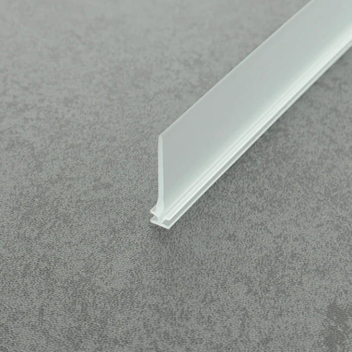 Micro-view of a chrome framed shower door replacement drip rail, showing how the 5mm T-head locks securely within metal frames (including chrome finishes) while the 28mm long soft fin reaches deep to the floor, providing a reliable bottom sealing barrier for shower doors with significant installation gaps.