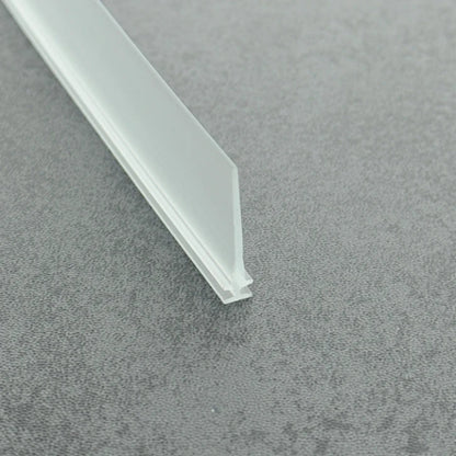 High-clarity close-up of a clear vinyl framed shower door drip sweep, showcasing the high light transmission, smooth vinyl texture, and exceptional flexibility of the VI001's 28mm long fin, highlighting its resistance to cracking when bent to effectively conform to various complex floor profiles while maintaining visual transparency.