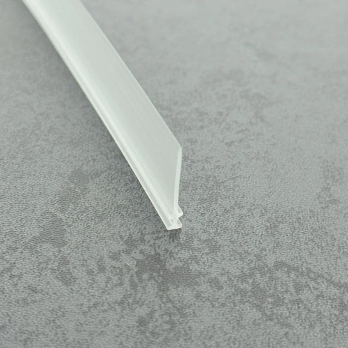 Micro-view of a framed shower door seal, showing how the 3mm T-head locks securely within aluminium or stainless steel frames while the 15mm long soft fin effectively adapts to slightly uneven floors, providing lasting scraping and sealing performance during door operation.