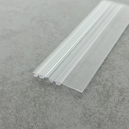 Close-up of the DOU03 clear centre-joint seal profile for framed folding shower doors
