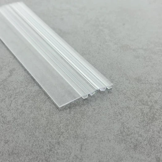 DOU03 clear folding shower door seal showing the extended rigid water-deflector wing