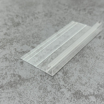 Close-up of F456S2535 clear PVC F shape shower seal with moulded trimming lines