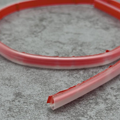 PV29 flexible shower threshold strip bent to follow curved and L-shaped shower tray layouts