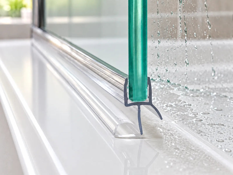 Clear shower door bottom seal fitted to the bottom edge of a glass shower door