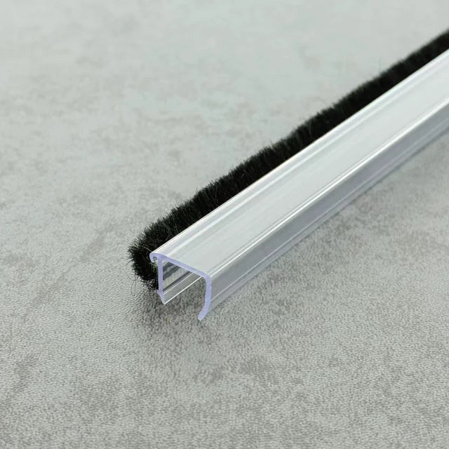 the S08 clear U-profile brush seal demonstrating how the black bristles create a seamless barrier against drafts and splashes.
