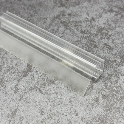 Close-up of the clear PVC SL810DTL shower door bottom seal with flexible side fin