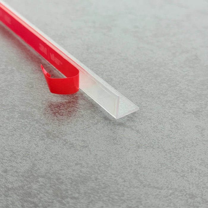 VG003 clear rigid seal installed between two parallel overlapping glass shower panels