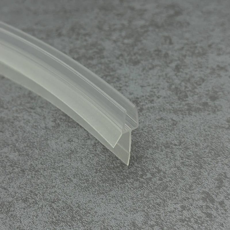Close-up of the clear PVC V810S8CU curved shower door bottom seal with short flexible fin