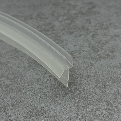 Close-up of the clear PVC V810S8CU curved shower door bottom seal with short flexible fin