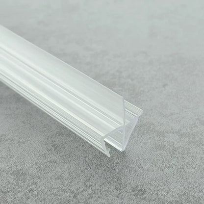 Close-up of the VC456 clear shower door bottom seal showing the rigid clip and offset flexible fin