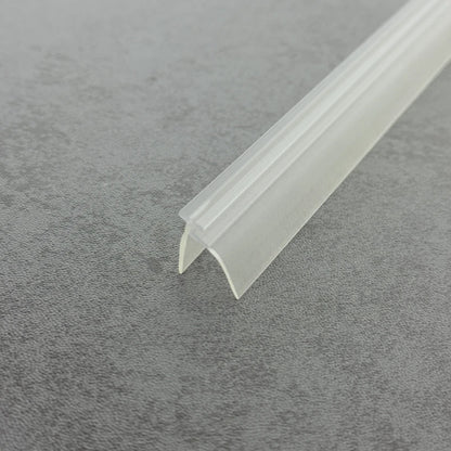 Angled view of the clear PVC VE03 framed shower door seal strip for compatible track channels