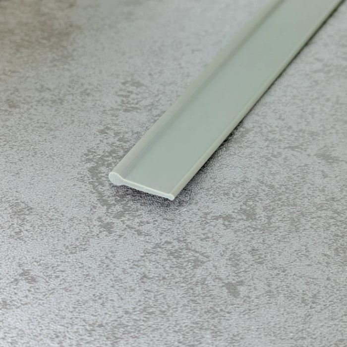 Close-up of the dark grey flexible PVC VF004 round bead bottom seal profile
